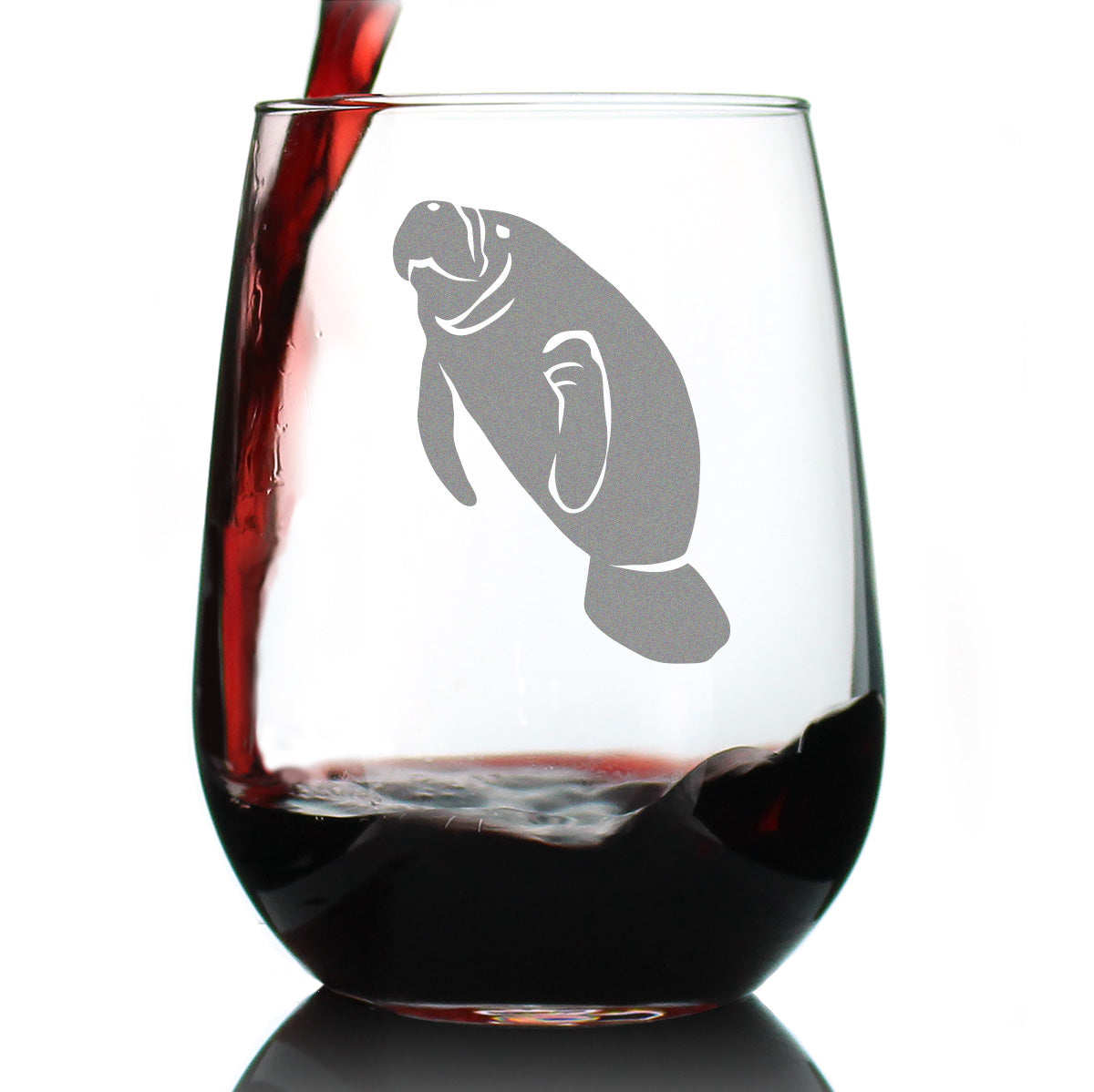 Stemless wine glass with an etched manatee design on it with red wine being poured into it against a white background.